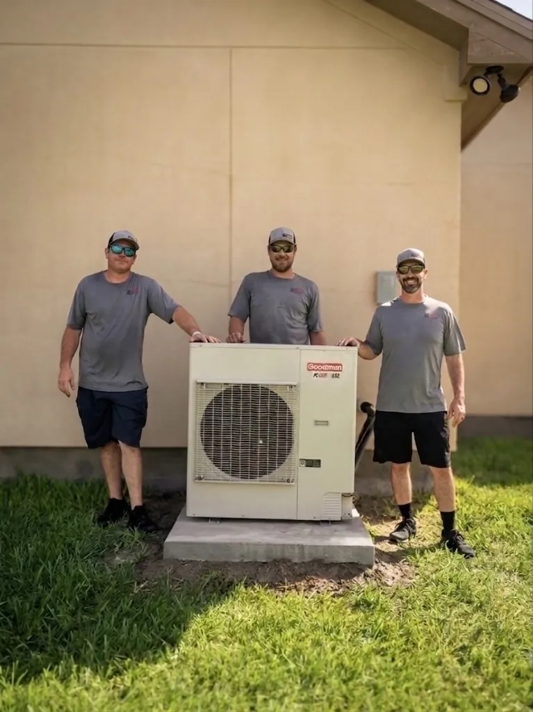 M&L HVAC technicians beside a completed Goodman system install
